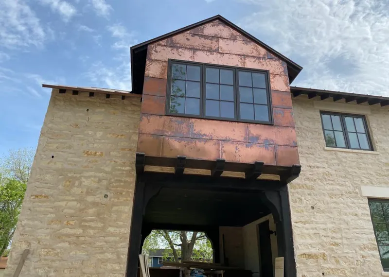 Copper metal panel facade on a stone building for Skylight Installation in Robstown